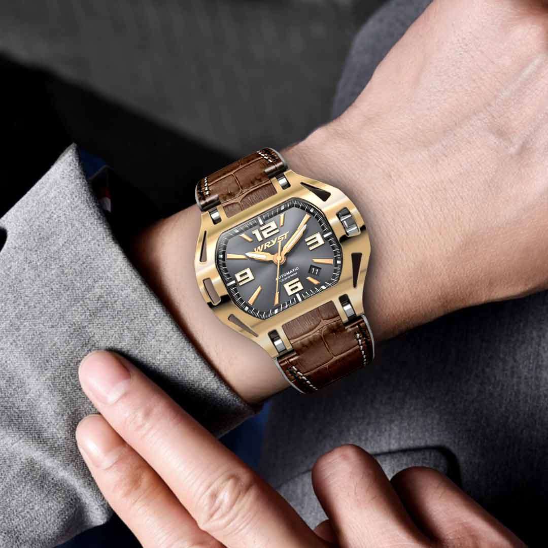 man wearing a gold swiss watch on the wrist